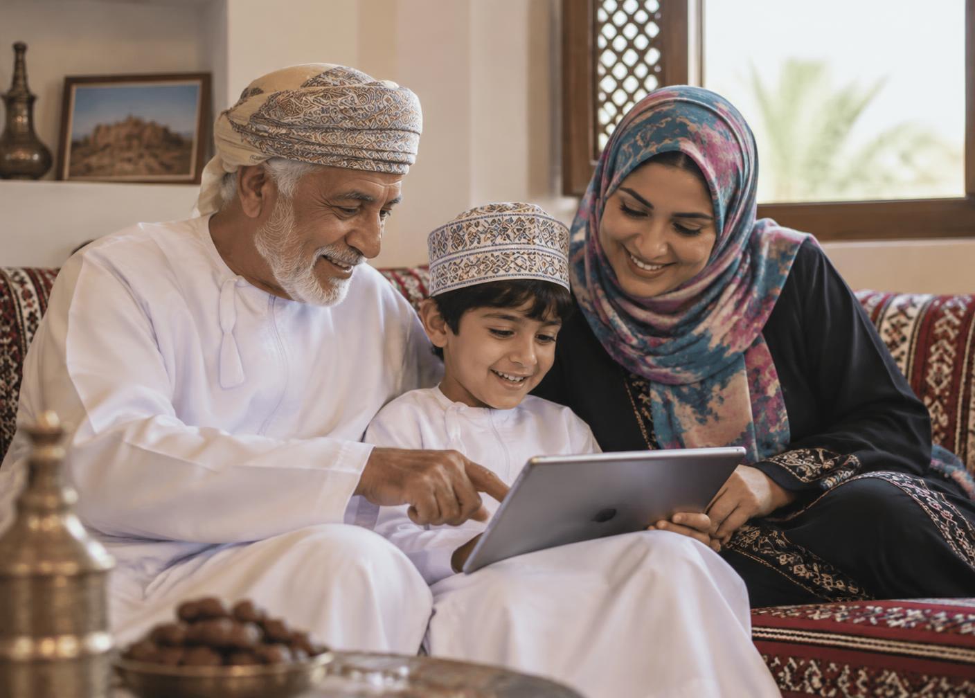 Three generations of an Omani family learning together on a tablet